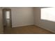 An open living area shows tile floors and a sliding glass door to the yard at 7570 Durham Hall Ave # 101, Las Vegas, NV 89130