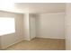 A bright living area features tile floors and neutral walls at 7570 Durham Hall Ave # 101, Las Vegas, NV 89130