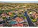 Aerial view showcasing the home's location on a tree-lined street with a golf course in the background at 8104 Wispy Sage Way, Las Vegas, NV 89149