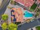 Aerial view of a well-maintained home with a tile roof, pool, spa, and lush landscaping at 8104 Wispy Sage Way, Las Vegas, NV 89149