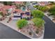 Stunning aerial shot showcases the home's manicured landscaping, solar panels, and circular driveway at 8104 Wispy Sage Way, Las Vegas, NV 89149