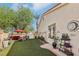 Back yard featuring green lawn, patio furniture, and a privacy fence at 8104 Wispy Sage Way, Las Vegas, NV 89149