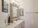Bright bathroom featuring a vanity with granite countertops and decorative mirrors at 8104 Wispy Sage Way, Las Vegas, NV 89149