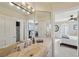 Bathroom showcasing a stone vessel sink, bright lighting, and access to an adjacent bedroom at 8104 Wispy Sage Way, Las Vegas, NV 89149