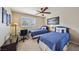 Well-lit bedroom featuring two twin beds, neutral walls, plush carpeting, and a ceiling fan at 8104 Wispy Sage Way, Las Vegas, NV 89149