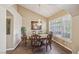 Elegant dining room with chandelier, decorative chairs, and large window with shutters at 8104 Wispy Sage Way, Las Vegas, NV 89149
