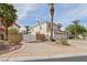 Spacious driveway leading to a three-car garage, framed by manicured landscaping and mature trees at 8104 Wispy Sage Way, Las Vegas, NV 89149