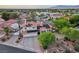 A beautiful two-story home with a tile roof, solar panels, three-car garage, and mature landscaping at 8104 Wispy Sage Way, Las Vegas, NV 89149