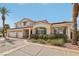 Inviting two-story home with a three-car garage, lovely landscaping, and a charming walkway at 8104 Wispy Sage Way, Las Vegas, NV 89149