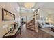 Grand foyer with soaring ceilings, chandelier, staircase, and tile flooring at 8104 Wispy Sage Way, Las Vegas, NV 89149