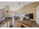 Eat-in kitchen featuring an island with a cooktop, granite counters, and access to the dining room at 8104 Wispy Sage Way, Las Vegas, NV 89149