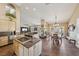 Gourmet kitchen and dining area, featuring granite countertops, an island cooktop, and a cozy fireplace at 8104 Wispy Sage Way, Las Vegas, NV 89149
