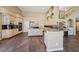 Bright open kitchen with granite countertops, tan cabinetry, wine fridge and high ceilings at 8104 Wispy Sage Way, Las Vegas, NV 89149