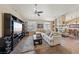 Cozy living room featuring a fireplace, tile flooring, and plenty of natural light at 8104 Wispy Sage Way, Las Vegas, NV 89149