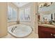 Modern main bathroom boasts a large soaker tub and lots of natural light at 8104 Wispy Sage Way, Las Vegas, NV 89149