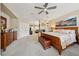 Comfortable main bedroom boasts ceiling fan, fireplace, and carpet flooring at 8104 Wispy Sage Way, Las Vegas, NV 89149
