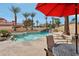 Enjoy outdoor living with this sparkling pool, lush landscaping, and inviting patio area at 8104 Wispy Sage Way, Las Vegas, NV 89149