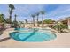 Gorgeous swimming pool and spa surrounded by lush landscaping and towering palm trees at 8104 Wispy Sage Way, Las Vegas, NV 89149