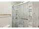 Modern walk-in shower with marble wall and shelves for toiletries at 8104 Wispy Sage Way, Las Vegas, NV 89149