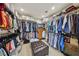 Spacious walk-in closet with custom storage solutions and central ottoman seating at 8104 Wispy Sage Way, Las Vegas, NV 89149
