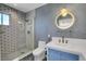 Stylish bathroom featuring a glass shower, unique tiling, and a round lighted mirror at 819 Bracken Ave, Las Vegas, NV 89104