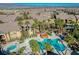 A beautiful aerial view of the community pool area with palm trees and well-maintained buildings at 8250 N Grand Canyon Dr # 2029, Las Vegas, NV 89166