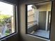 Balcony views of landscaping, stairs, and other condos through open windows at 8250 N Grand Canyon Dr # 2029, Las Vegas, NV 89166