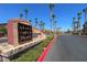 Grand Canyon Village entrance sign surrounded by landscaped bushes and rows of palm trees at 8250 N Grand Canyon Dr # 2029, Las Vegas, NV 89166