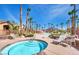 Community spa surrounded by lounge chairs and palm trees at 8250 N Grand Canyon Dr # 2029, Las Vegas, NV 89166