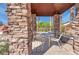 Outdoor pavilion seating area with stone pillars and iron chairs and table at 8250 N Grand Canyon Dr # 2029, Las Vegas, NV 89166