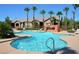 A refreshing community pool with a waterfall feature and lounge chairs for relaxing in the sun at 8250 N Grand Canyon Dr # 2029, Las Vegas, NV 89166