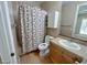 Bathroom with shower-tub combo, patterned shower curtain, and wooden vanity at 8777 Beckett Ridge Ave, Las Vegas, NV 89149