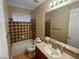 Traditional bathroom with a shower-tub combo and a tiled backsplash at 8777 Beckett Ridge Ave, Las Vegas, NV 89149