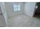 This bedroom features tile flooring and a bright window at 8777 Beckett Ridge Ave, Las Vegas, NV 89149