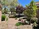 Lovely outdoor area with a patio table and lush greenery creates a peaceful retreat at 8777 Beckett Ridge Ave, Las Vegas, NV 89149