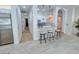 Open concept featuring kitchen, bar seating, and stainless steel refrigerator at 8777 Beckett Ridge Ave, Las Vegas, NV 89149