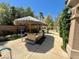 Backyard patio with Tiki hut and outdoor kitchen at 8777 Beckett Ridge Ave, Las Vegas, NV 89149