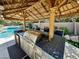 Tiki hut featuring a built-in outdoor kitchen and bar at 8777 Beckett Ridge Ave, Las Vegas, NV 89149