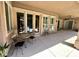 Comfortable covered patio with table and chairs offers a shady spot to relax and enjoy the beautiful outdoor weather at 8777 Beckett Ridge Ave, Las Vegas, NV 89149