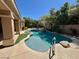 A tranquil pool with tropical landscaping and rock features, a soothing retreat to cool off in the hot summer at 8777 Beckett Ridge Ave, Las Vegas, NV 89149