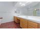 Bathroom featuring a double vanity, large mirror, and shower over tub with glass doors at 9091 W Viking Rd, Las Vegas, NV 89147
