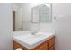 Bathroom vanity with white countertop, a mirror, and a wooden cabinet at 9091 W Viking Rd, Las Vegas, NV 89147
