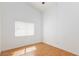 A bright bedroom with wood-look floors and a window with horizontal blinds at 9091 W Viking Rd, Las Vegas, NV 89147