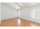 Spacious bedroom featuring wood-look flooring, fan, and windows for natural light at 9091 W Viking Rd, Las Vegas, NV 89147
