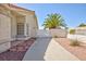Welcoming front entrance with desert landscaping and privacy gate leading to backyard at 9091 W Viking Rd, Las Vegas, NV 89147