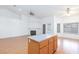 Spacious living room with wood flooring, fireplace, and an island at 9091 W Viking Rd, Las Vegas, NV 89147