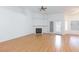 Bright living room featuring wood floors, fireplace, and ceiling fan at 9091 W Viking Rd, Las Vegas, NV 89147