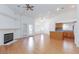 Open-concept living room showcasing wood floors, a fireplace, and a partial view of the kitchen at 9091 W Viking Rd, Las Vegas, NV 89147