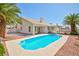 Wide angle shot of backyard pool with desert landscaping, showing house exterior at 9091 W Viking Rd, Las Vegas, NV 89147