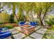 Inviting backyard space with a stone fire pit and comfortable blue seating at 9500 Balatta Canyon Ct, Las Vegas, NV 89144